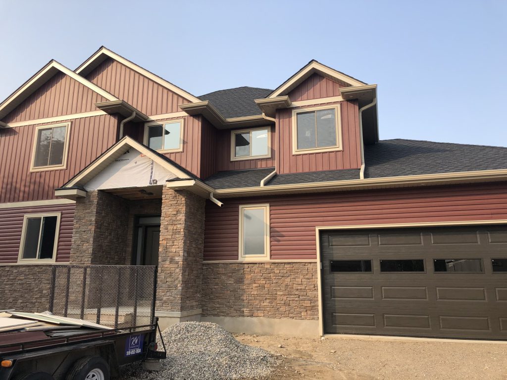 Finished home exterior with garage and entry