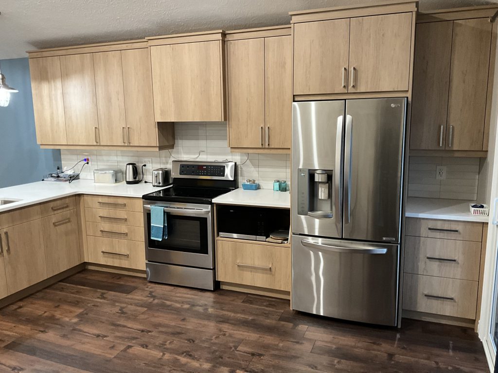 Renovated kitchen cabinetry and appliance wall