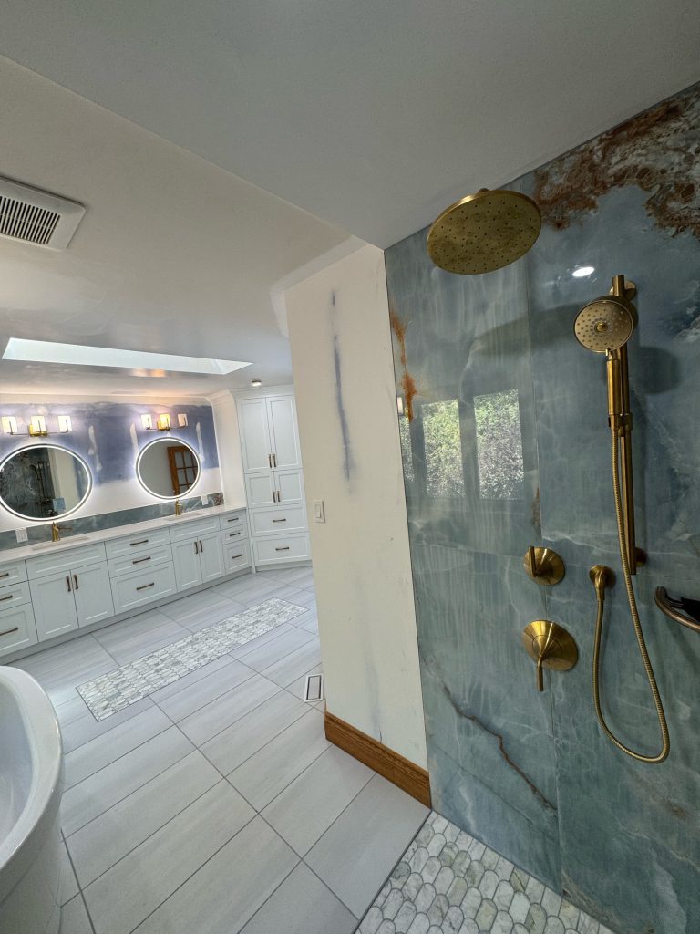 Detail of dark shower tile and brass fixtures
