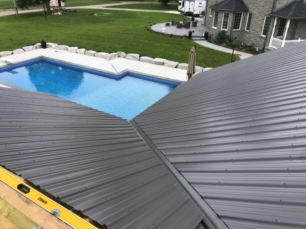 Pool house roof panels viewed beside the swimming pool