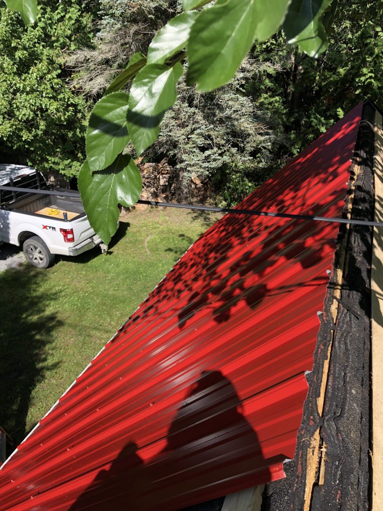 Detail of the red barn-steel roof along the ridge