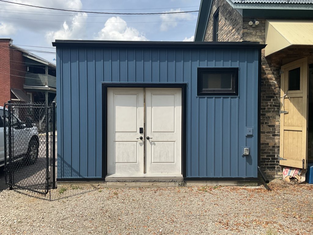 Front elevation after the new blue siding was installed