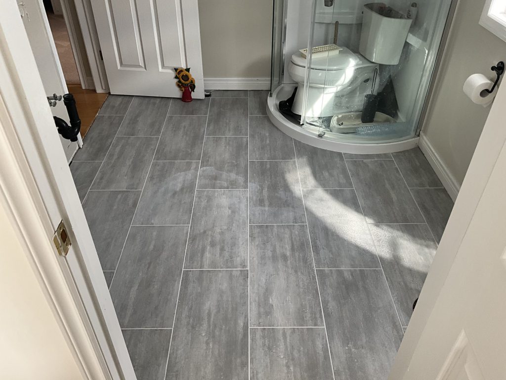 New floor tile leading into the bathroom shower